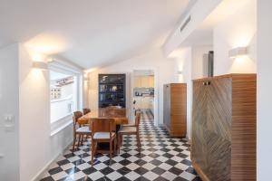 a kitchen and dining room with a table and chairs at The Roof Sorrento in Sorrento