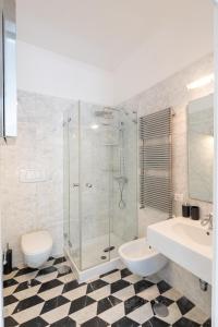 a bathroom with a shower and a toilet and a sink at The Roof Sorrento in Sorrento