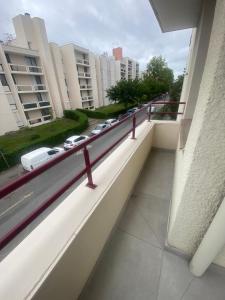a balcony with a view of a street with cars at AG Immobilier 95 in Bezons