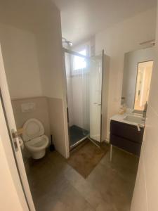 a bathroom with a toilet and a shower and a sink at AG Immobilier 95 in Bezons
