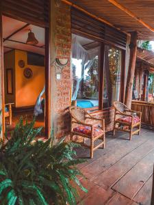 a porch with two chairs and a table at Sipi Falls Lodge in Sipi
