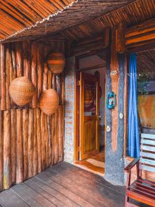 an entrance to a wooden house with baskets on the wall at Sipi Falls Lodge in Sipi