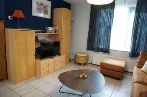 a living room with a couch and a table at Kustverhuur, Park Schoneveld, Stern 233 in Breskens
