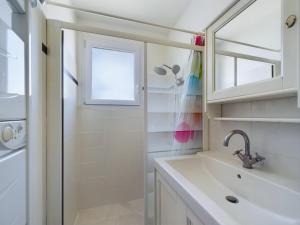 a bathroom with a sink and a shower at Maison pour 8 avec jardin a 600m de la plage in Le Sablais +23 photos