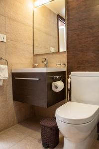 La salle de bains est pourvue de toilettes, d'un lavabo et d'un miroir. dans l'établissement Marble Tower, à Beyrouth