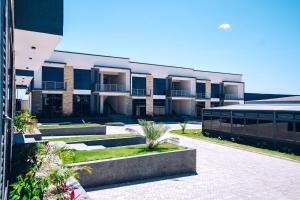 an apartment building with a courtyard with plants at Kipepeo Apartments in Nkongontha