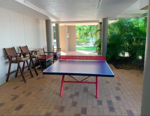 a ping pong table in the middle of a room at Emohruo Rainbow Shores - 3 Br Resort Apartment in Rainbow Beach