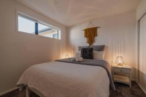 a bedroom with a large bed and a window at The Hagley Park Stunna in Christchurch