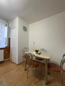 a dining room with a table and chairs at Apartament Andrei in Turda +5 photos