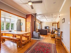 a living room with a wooden table and a couch at MJ's Retreat Stunning Ski Season Special for 2024 in Ohakune