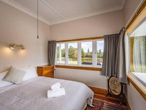 a bedroom with a large bed and a window at MJ's Retreat Stunning Ski Season Special for 2024 in Ohakune