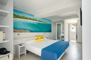 a bedroom with a bed with a painting on the wall at Ryans La Marina in Ibiza Town +75 photos