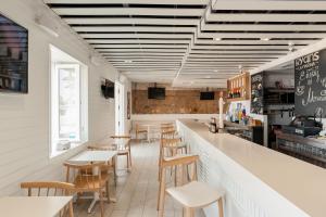 a restaurant with a bar with wooden chairs and tables at Ryans La Marina in Ibiza Town