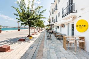 a street with tables and chairs next to a building at Ryans La Marina in Ibiza Town