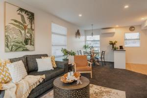 a living room with a couch and a table at The Dream Townhouse in Christchurch +14 photos