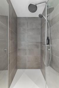 a shower with a glass door in a bathroom at Leneshus in Flensburg +38 photos