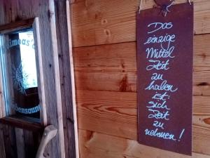 a sign on the side of a wooden wall at Panorama Chalet mit Sauna Höllmaishof in Bischofshofen +46 photos