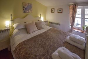 a bedroom with a large bed and a window at La Maison Muguet in Civray