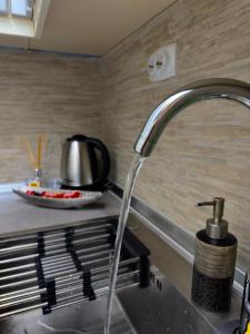 a kitchen sink with a water faucet at NOA Luxury Apartment in Bitola