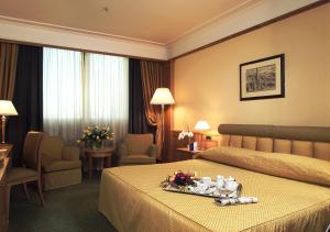 Postel nebo postele na pokoji v ubytování Grand Hotel Barone Di Sassj