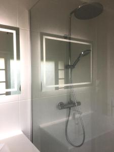 a shower with a shower head in a bathroom at St-Clair Villa, piscine & pinède in Sète