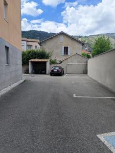 a car parked in a parking lot next to a house at Détente en provence in Digne-les-Bains
