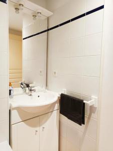 a white bathroom with a sink and a mirror at Détente en provence in Digne-les-Bains +21 photos