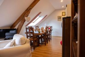 a kitchen and dining room with a table and chairs at Ferme de Marpalu in La Ferté-Saint-Cyr