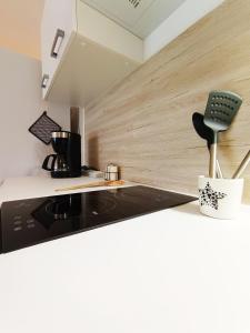 a kitchen with a counter with a stove top oven at Détente en provence in Digne-les-Bains