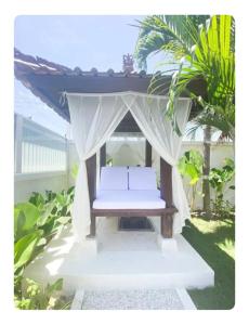 a bed in a gazebo with a canopy at Cozzy room in heart of Canggu#1 in Canggu