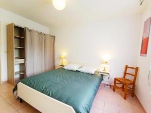 a bedroom with a bed with a green comforter at Détente en provence in Digne-les-Bains
