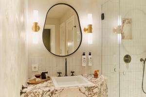 a bathroom with a sink and a mirror at Revier in Oslo