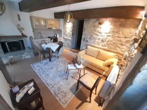 an aerial view of a living room with a stone wall at Elen's Suites Pramanta in Pramanta