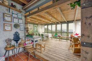 a large living room with wooden floors and windows at Vineyard Cottage Verček - Happy Rentals in Novo Mesto