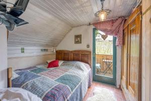a bedroom with a bed and a window at Vineyard Cottage Verček - Happy Rentals in Novo Mesto