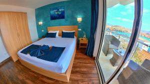 Postel nebo postele na pokoji v ubytování Blue Marlin Hotel + 37 fotografií