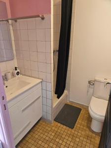 a bathroom with a toilet and a sink and a shower at Laurier in Challans