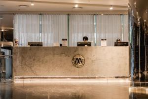 a reception desk in a lobby with people sitting at desks at Premium Luxury Sub-Penthouse in Melbourne +20 photos
