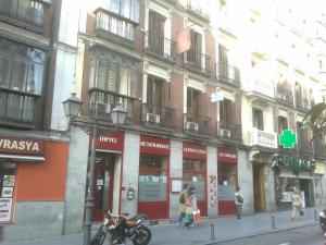 a group of buildings on a city street with a motorcycle at Hostal New Life Madrid in Madrid