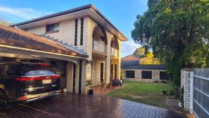 a car parked in the garage of a house at Big Holliday house with pool in Brisbane