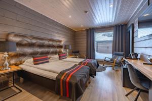 a hotel room with a bed and a desk at Wilderness Hotel Inari & Igloos in Inari
