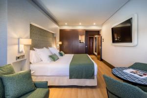 A bed or beds in a room at Barceló Granada Congress