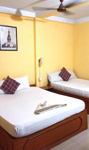 Кровать или кровати в номере The Lumbini Village Lodge