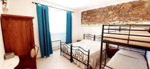 A bed or beds in a room at DIMORA IL CAMALEONTE apartments in nature with pool