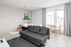 a living room with a couch and a table at Hiisi Homes Kangasala in Suorama +61 photos