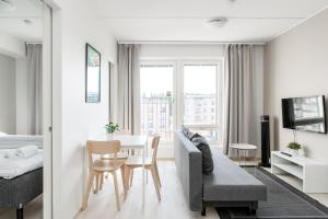 a living room with a couch and a table at Hiisi Homes Kangasala in Suorama