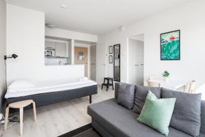 a living room with a bed and a couch at Hiisi Homes Kangasala in Suorama