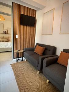 a living room with a couch and a tv at Stylish unit with amazing view in Hentiesbaai