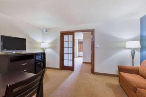 a living room with a couch and a television at AmericInn by Wyndham Monmouth in Monmouth