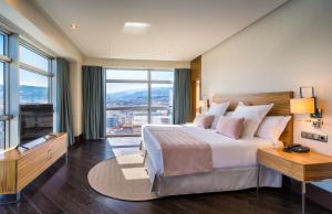 A bed or beds in a room at Barceló Granada Congress